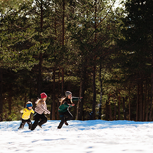 Children running on the snow